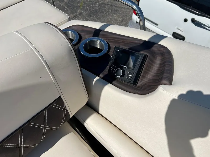 Slide: The Image of Bennington R 25 RSB 2020 boat interior with cup holders and control panel. - 9