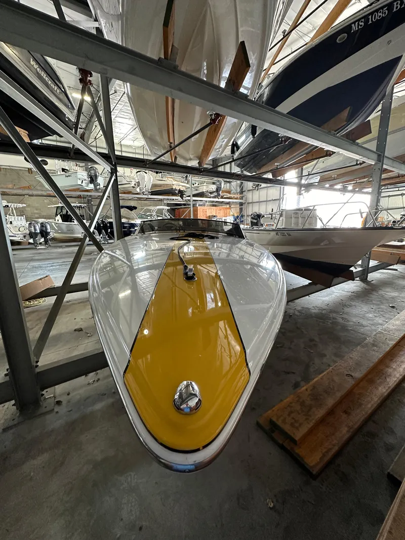 Slide: The Image of 1995 Donzi 22 Classic boat in storage, yellow and white hull. - 5