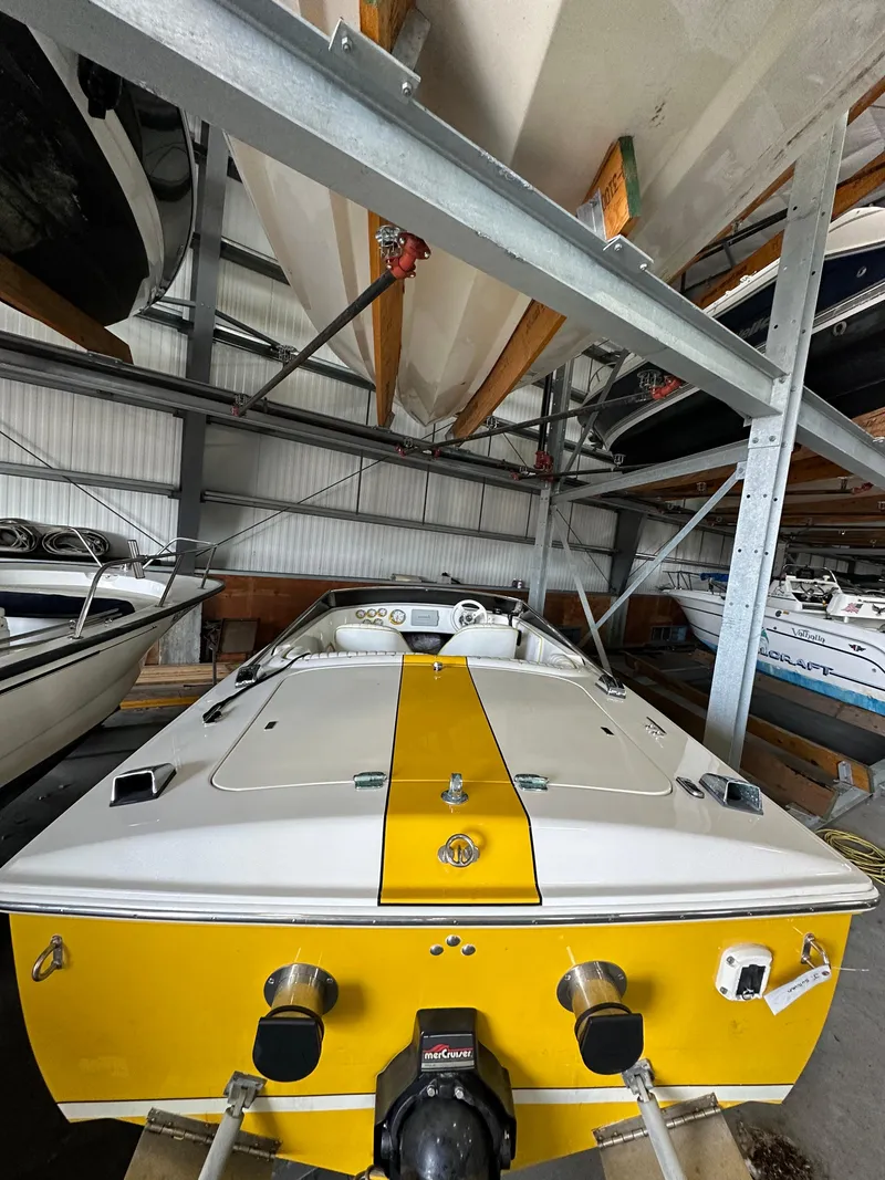 Slide: The Image of 1995 Donzi 22 Classic boat in storage, yellow and white color scheme. - 8