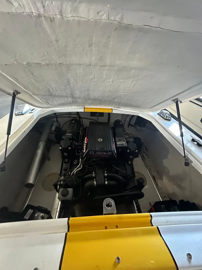 Slide: The Image of 1995 Donzi 22 Classic boat engine compartment with open hatch, showcasing powerful engine. - 9