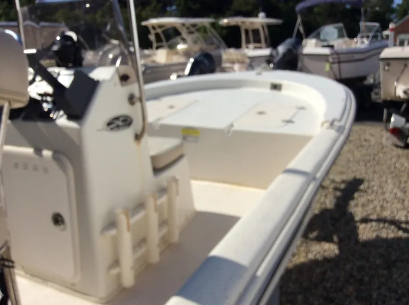 Slide: The Image of 2016 Carolina Skiff JUX 16 boat, white, docked among other boats. - 4