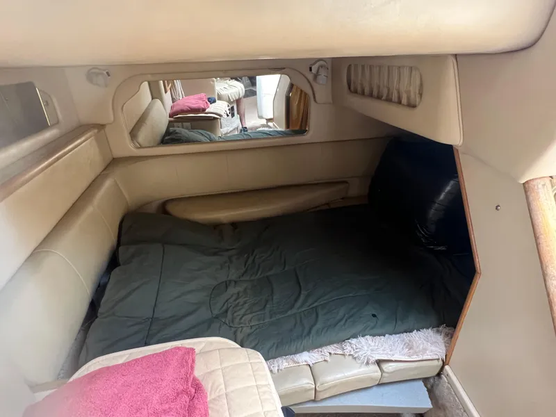 Slide: The Image of 1998 Sea Ray 330 Sundancer cabin interior with bed and mirror. - 17