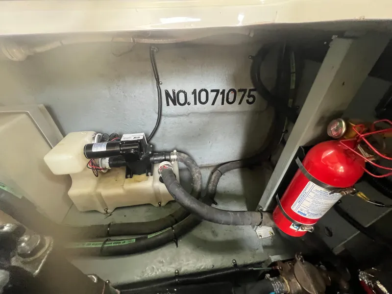 Slide: The Image of Engine compartment of a 1998 Sea Ray 330 Sundancer with fire extinguisher and serial number. - 22