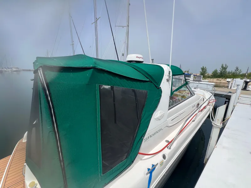 Slide: The Image of 1998 Sea Ray 330 Sundancer docked with green canopy. - 4