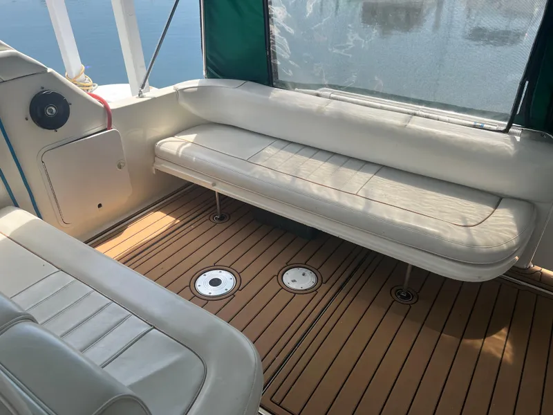 Slide: The Image of 1998 Sea Ray 330 Sundancer boat interior with white seating and teak flooring. - 5
