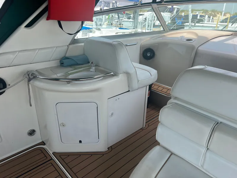 Slide: The Image of 1998 Sea Ray 330 Sundancer interior with white seating and wood flooring. - 6