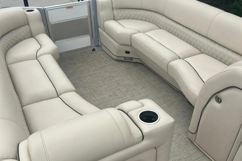 Slide: The Image of 2019 Barletta L25U pontoon boat interior with beige leather seating and cup holders. - 6