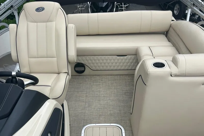 Slide: The Image of 2019 Barletta L25U boat interior with beige leather seating and cup holders. - 7