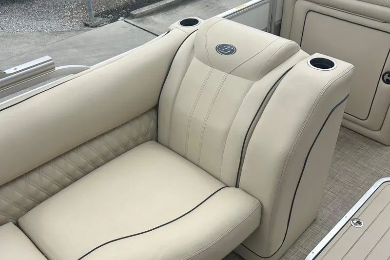 Slide: The Image of 2019 Barletta L25U boat interior with beige leather seating and cup holders. - 8