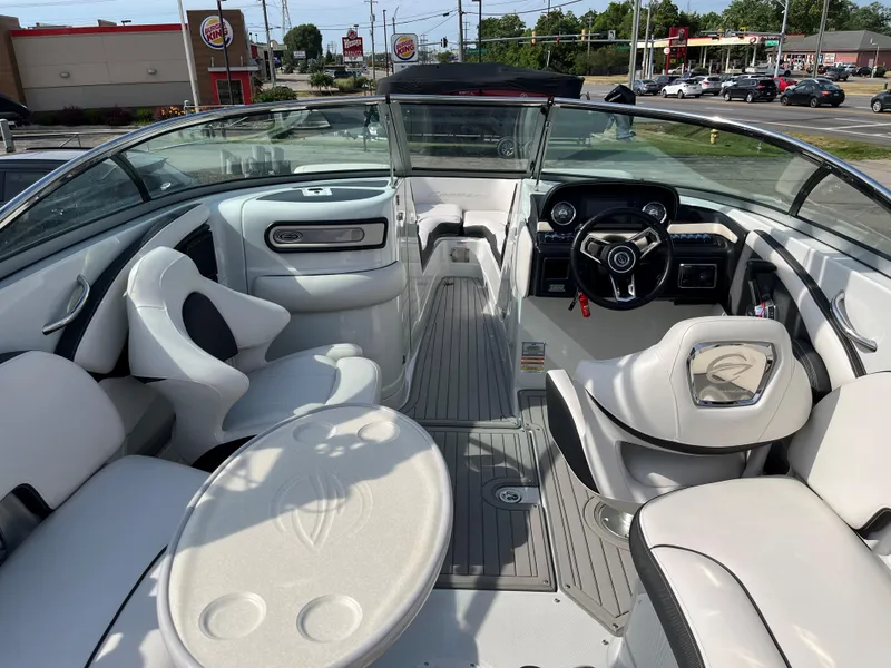 Slide: The Image of 2019 Crownline 265 SS SURF boat interior with seating and dashboard. - 2