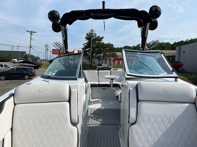 Slide: The Image of 2019 Crownline 265 SS SURF boat with white interior and open deck. - 5