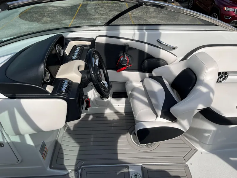 Slide: The Image of 2019 Crownline 265 SS SURF boat interior with steering wheel and captain's chair. - 7