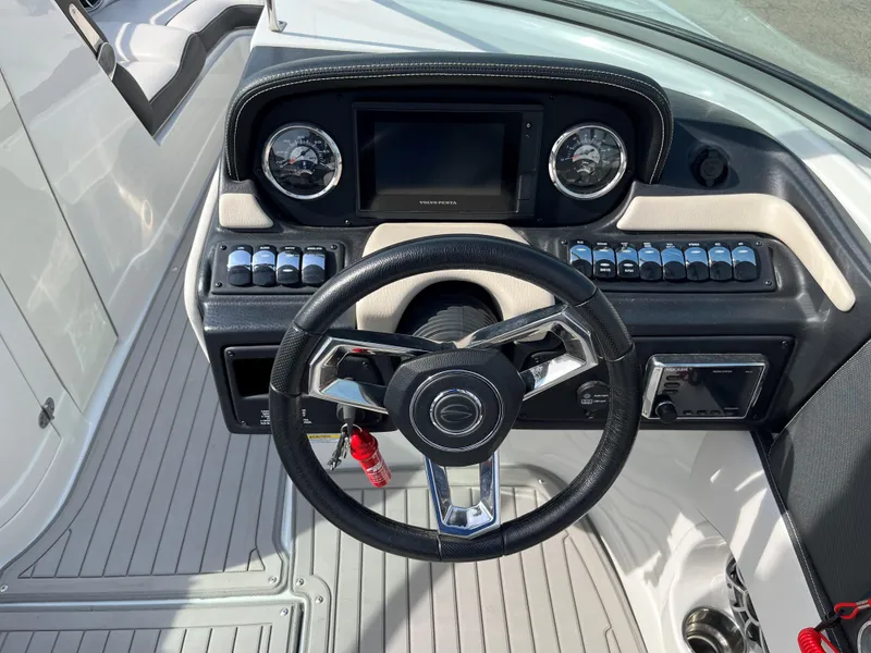 Slide: The Image of 2019 Crownline 265 SS SURF boat dashboard with steering wheel and control panel. - 8