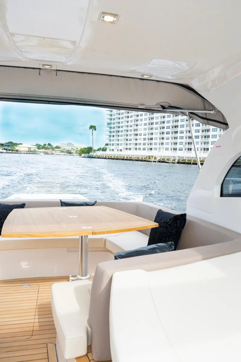 Slide: The Image of Luxurious interior of 2024 Sessa Marine C44 Cruiser with elegant seating and dining area. - 10