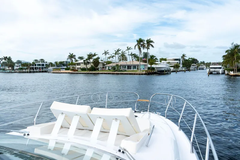 Slide: The Image of 2024 Sessa Marine C44 Cruiser interior with captain at helm, featuring sleek design and wood flooring. - 6