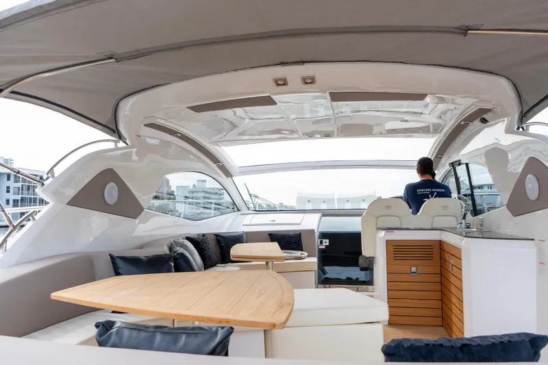 Slide: The Image of Luxurious 2024 Sessa Marine C44 Cruiser interior with elegant seating and wooden flooring. - 7