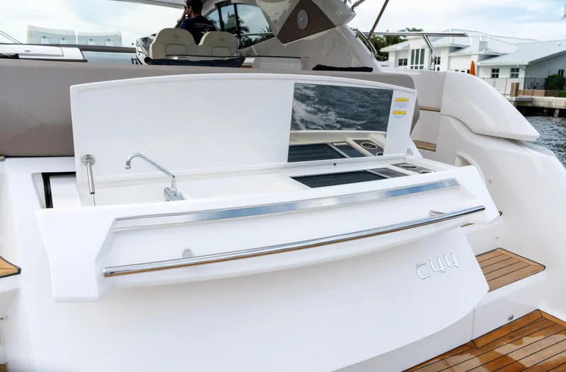 Slide: The Image of 2024 Sessa Marine C44 Cruiser interior with waterfront view and luxury seating. - 9