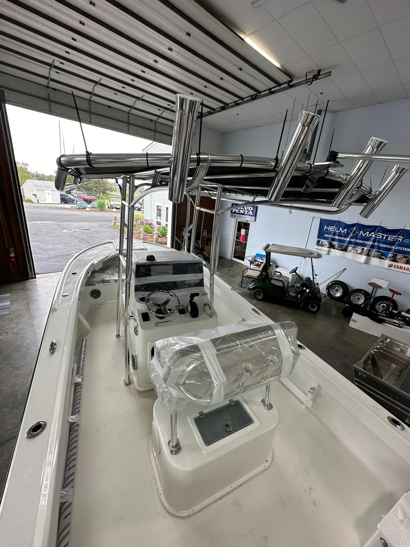 Slide: The Image of 2025 Parker 21SE Center Console boat in a garage, showcasing its sleek design and modern features. - 10