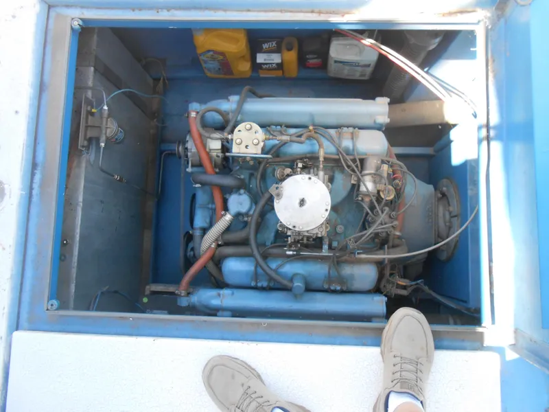 Slide: The Image of 1969 River Queen Houseboat engine compartment with visible engine and maintenance supplies. - 10