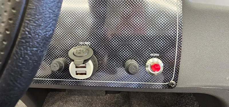 Slide: The Image of Dashboard of 2024 Tracker Bass Tracker Classic XL with USB port and horn button. - 11