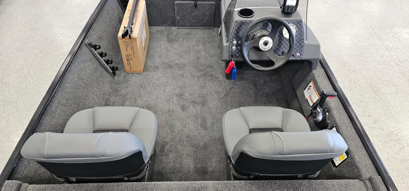 Slide: The Image of 2024 Tracker Bass Tracker Classic XL boat interior with two seats and steering console. - 6