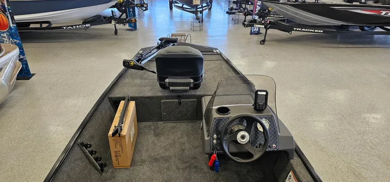 Slide: The Image of 2024 Tracker Bass Tracker Classic XL boat interior with steering wheel and equipment. - 7