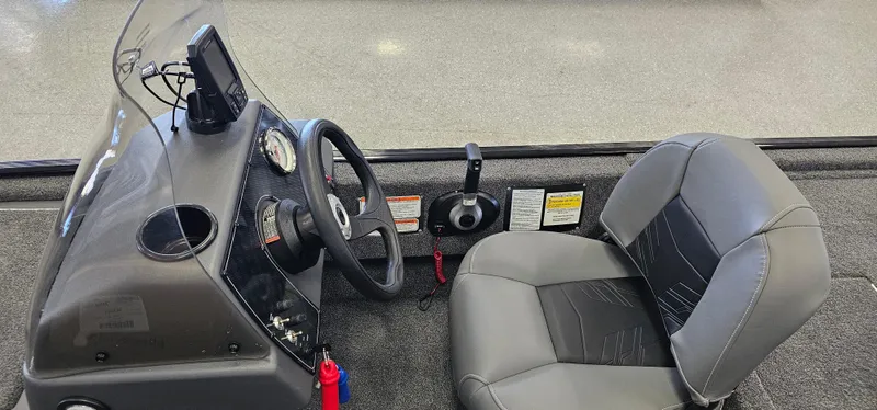 Slide: The Image of 2024 Tracker Bass Tracker Classic XL boat interior with steering wheel and seat. - 8