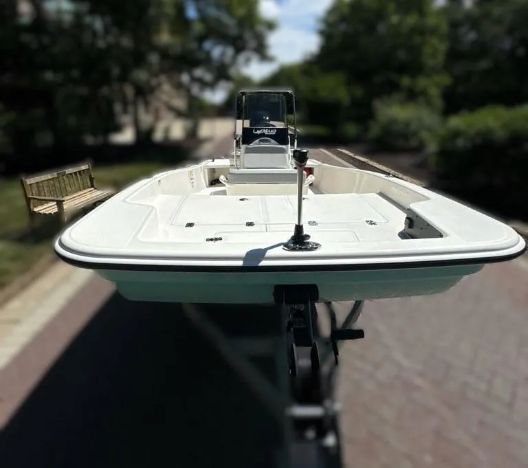Slide: The Image of 2024 Mako Pro Skiff 15 CC boat on a trailer, front view. - 2