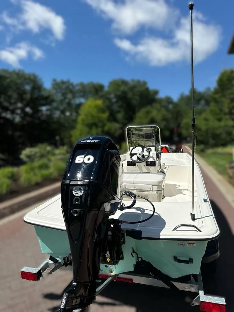 Slide: The Image of 2024 Mako Pro Skiff 15 CC with 60 HP engine on trailer. - 3