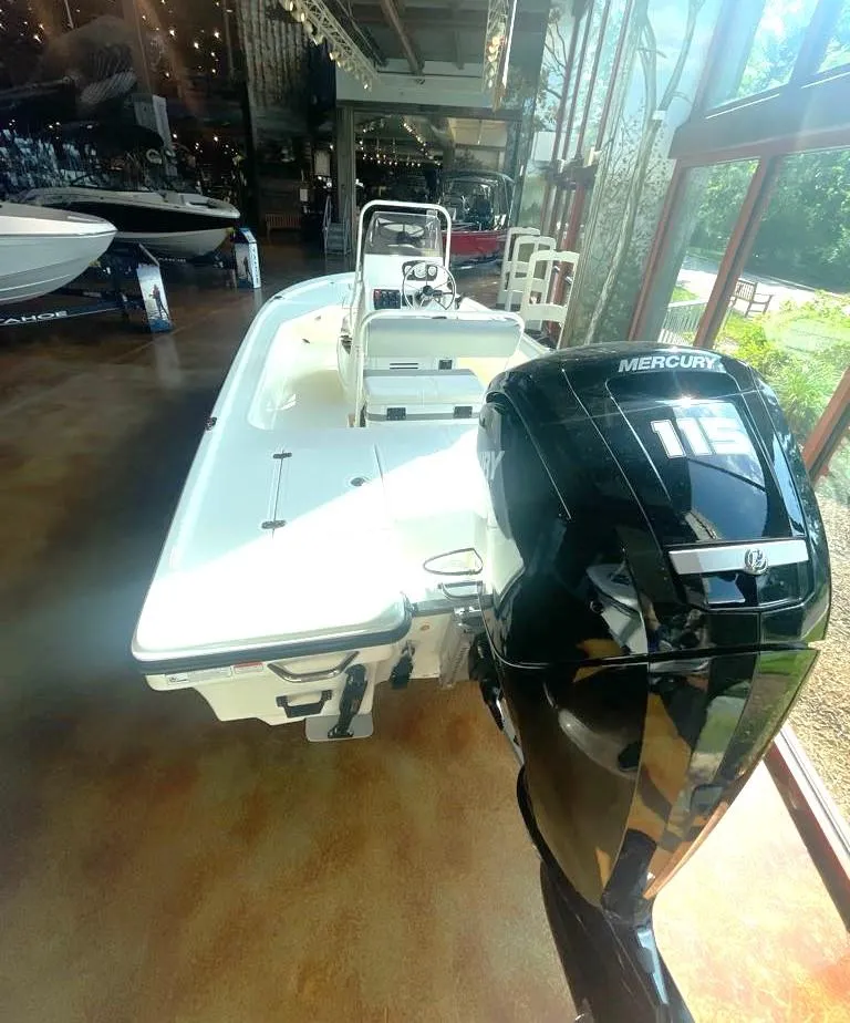 Slide: The Image of 2024 Mako 18 LTS boat with Mercury 115 engine displayed in showroom. - 2