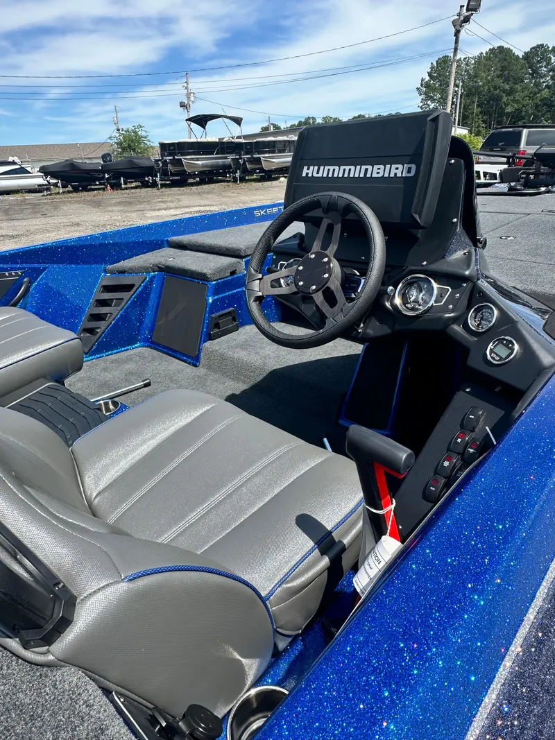 Slide: The Image of 2024 Skeeter ZXR21 boat interior with Humminbird electronics and gray seating. - 11