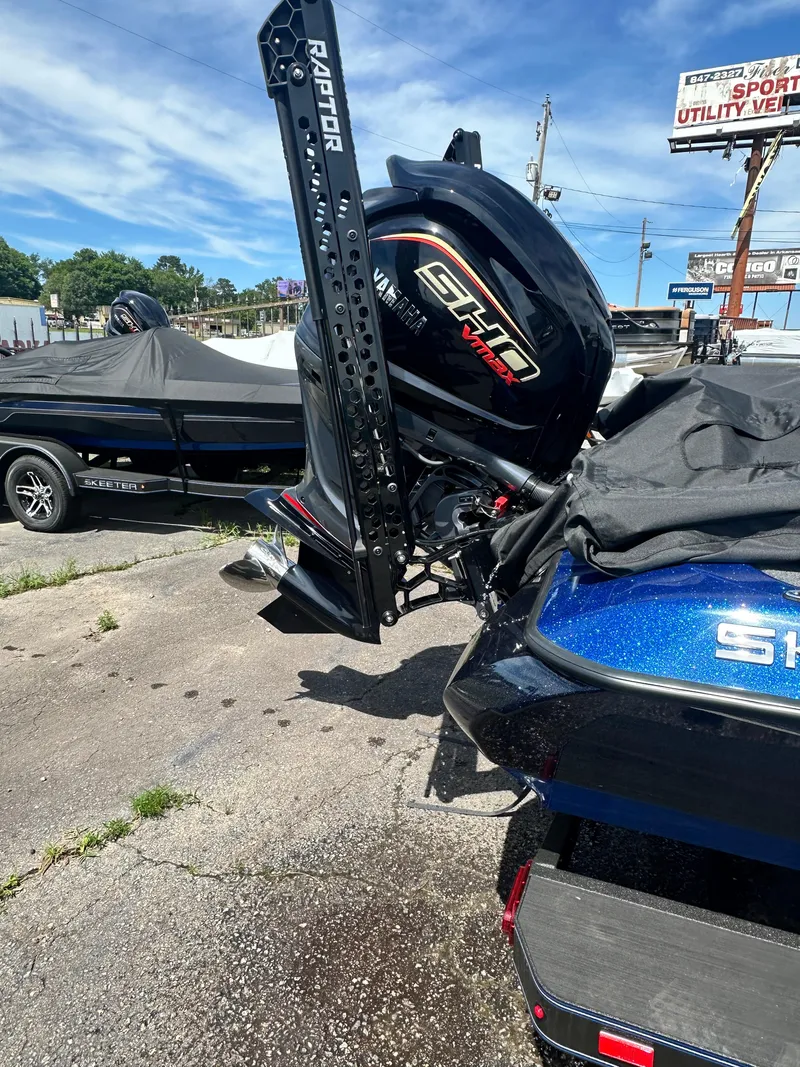 Slide: The Image of 2024 Skeeter ZXR21 boat with SHP motor and Raptor mount in a dealership lot. - 12