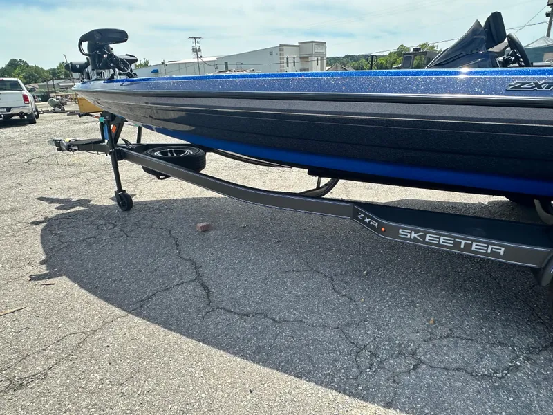 Slide: The Image of 2024 Skeeter ZXR21 boat on trailer in parking lot. - 4