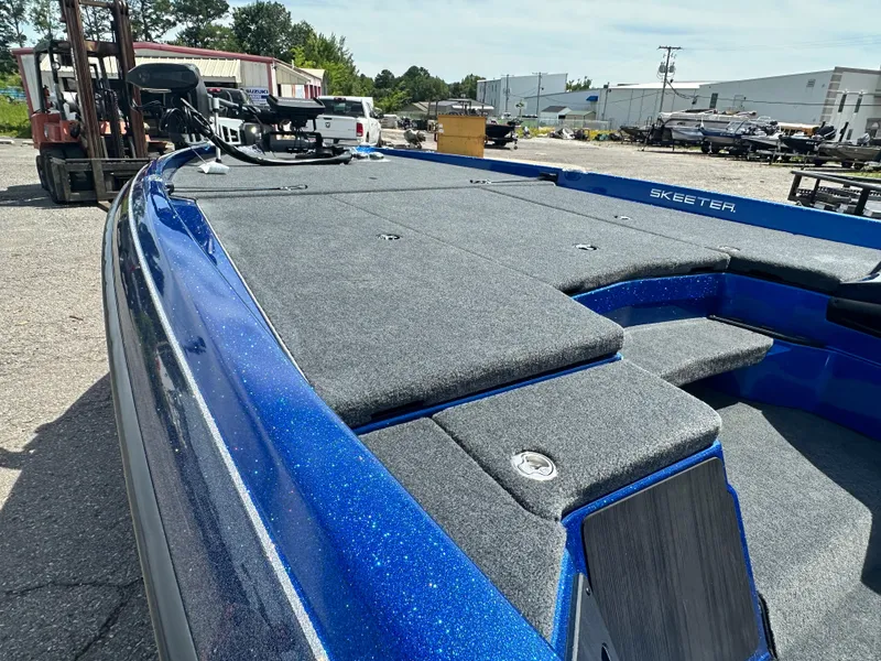 Slide: The Image of 2024 Skeeter ZXR21 boat with blue exterior and spacious deck. - 7