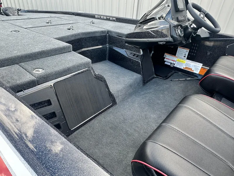 Slide: The Image of 2024 Skeeter ZX150 boat interior with steering console and seating. - 3