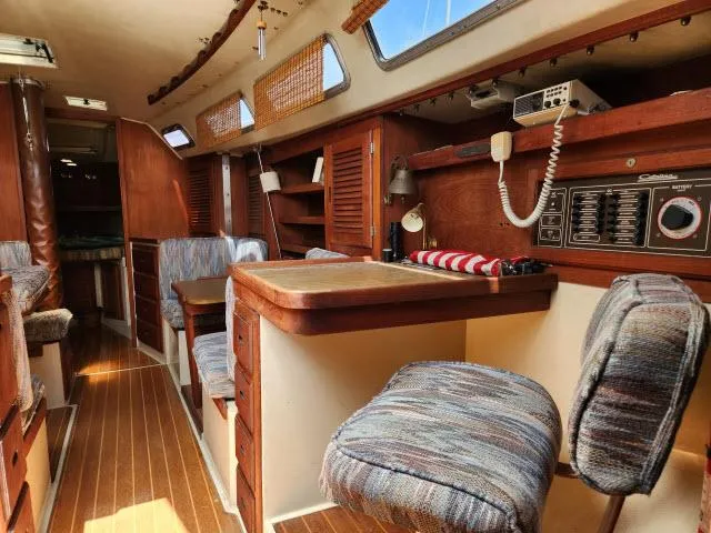 Slide: The Image of Interior of a 1985 Catalina 36 sailboat with wooden furnishings and seating. - 15