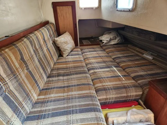Slide: The Image of Interior cabin of a 1985 Catalina 36 sailboat with plaid seating. - 17