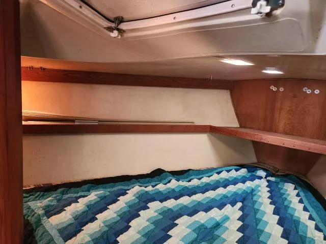 Slide: The Image of Interior cabin of a 1985 Catalina 36 sailboat with a blue quilted bed. - 21