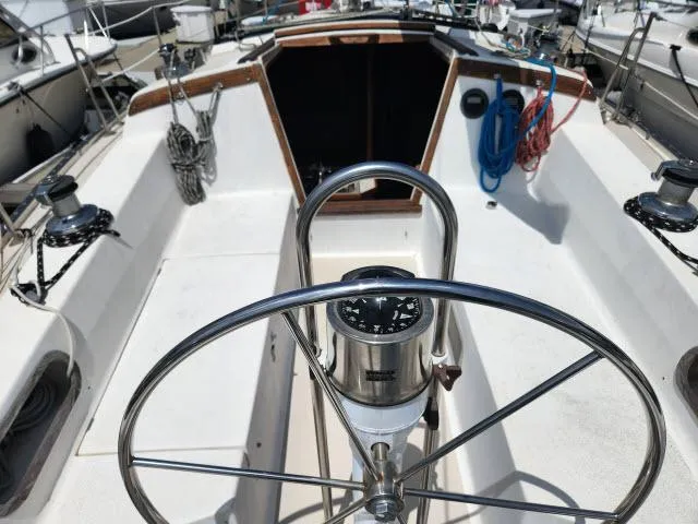 Slide: The Image of Cockpit of a 1985 Catalina 36 sailboat with steering wheel and navigation instruments. - 25