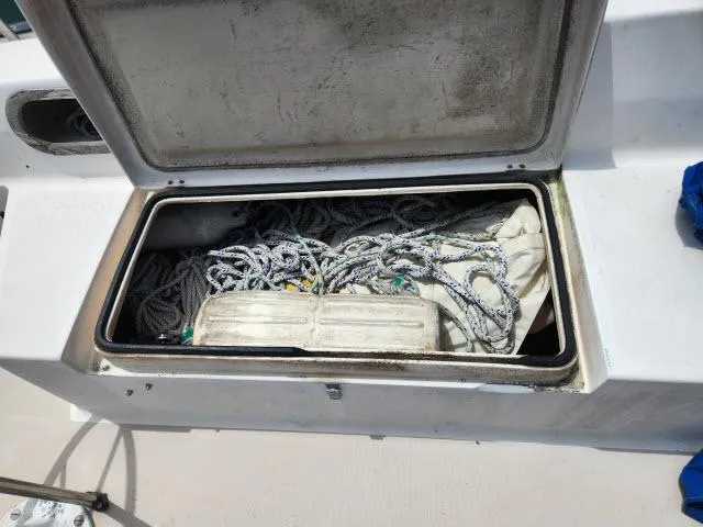 Slide: The Image of Open storage compartment on a 1985 Catalina 36 sailboat with ropes and equipment. - 29
