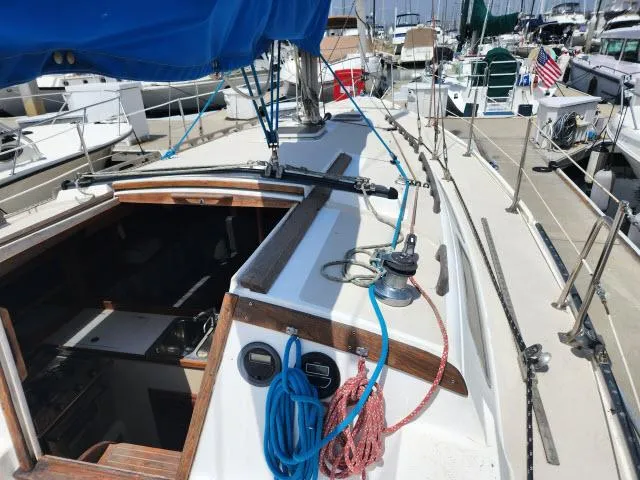 Slide: The Image of 1985 Catalina 36 sailboat docked at marina, view of deck and cabin entrance. - 33