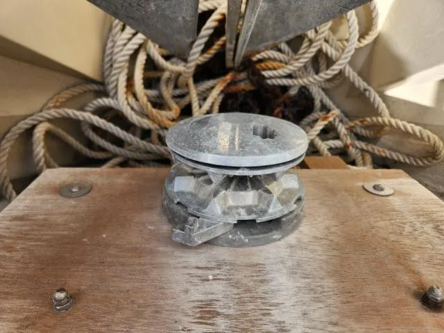 Slide: The Image of Anchor windlass on a 1985 Catalina 36 sailboat with coiled ropes in the background. - 37