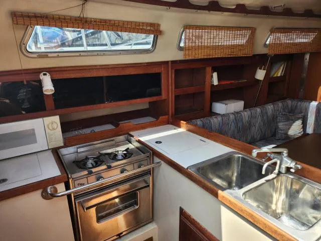 Slide: The Image of Interior of 1985 Catalina 36 sailboat with kitchen and seating area. - 4