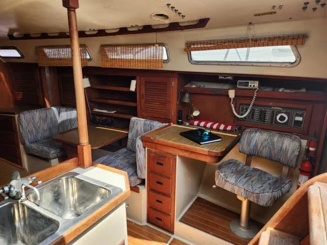 Slide: The Image of Interior of 1985 Catalina 36 sailboat with kitchen, dining area, and navigation station. - 5
