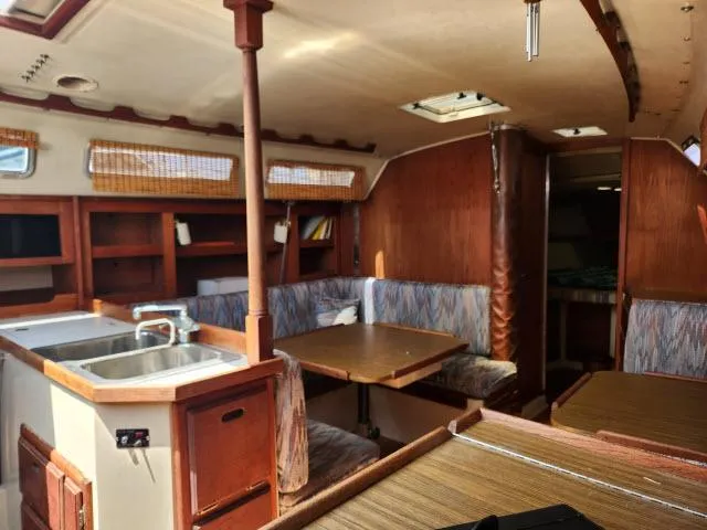 Slide: The Image of Interior of 1985 Catalina 36 sailboat with kitchen, dining area, and wooden cabinetry. - 6