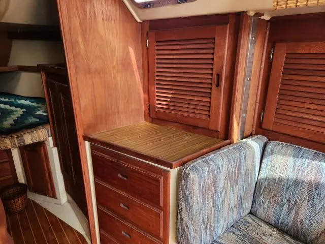Slide: The Image of Interior of 1985 Catalina 36 sailboat with wooden cabinets and cushioned seating. - 9