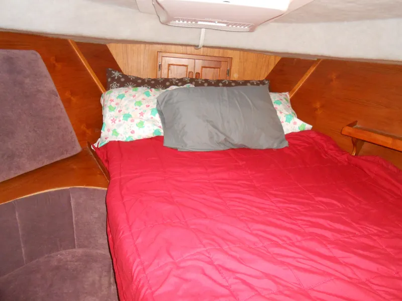 Slide: The Image of Cozy cabin bed in 1989 Cooper Marine Prowler 9m boat with red bedding. - 12