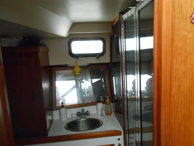 Slide: The Image of Interior of 1989 Cooper Marine Prowler 9m boat with sink and mirror. - 14