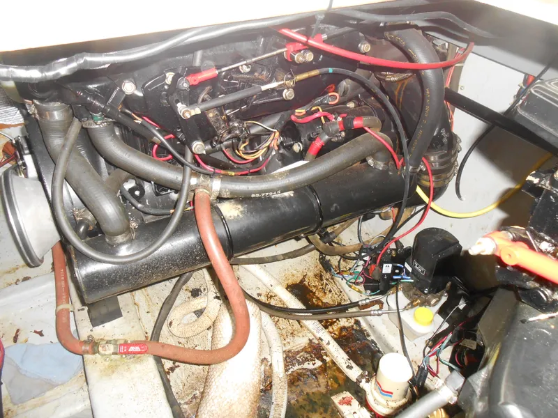 Slide: The Image of Engine compartment of a 1989 Cooper Marine Prowler 9m boat with visible wiring and hoses. - 19