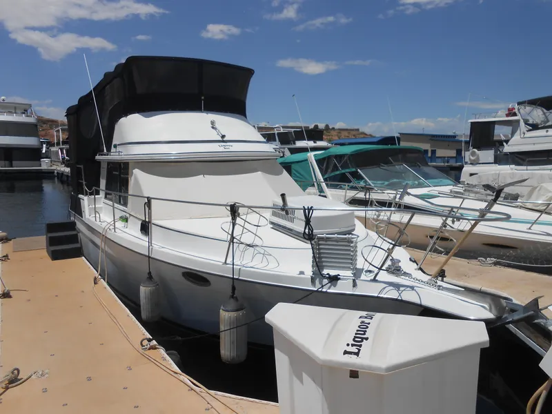 Slide: The Image of 1989 Cooper Marine Prowler 9m docked at a marina on a sunny day. - 2